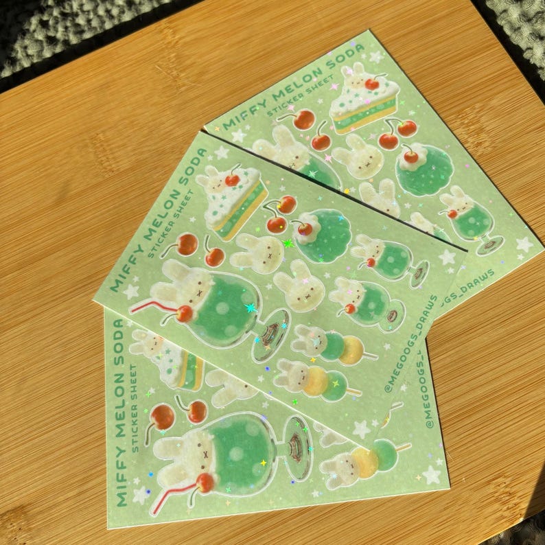 May include: Two sticker sheets with a light green background featuring illustrations of a bunny, desserts, and drinks. The text "MIFFY MELON SODA STICKER SHEET" is printed on the stickers. The stickers have a cute, whimsical design.