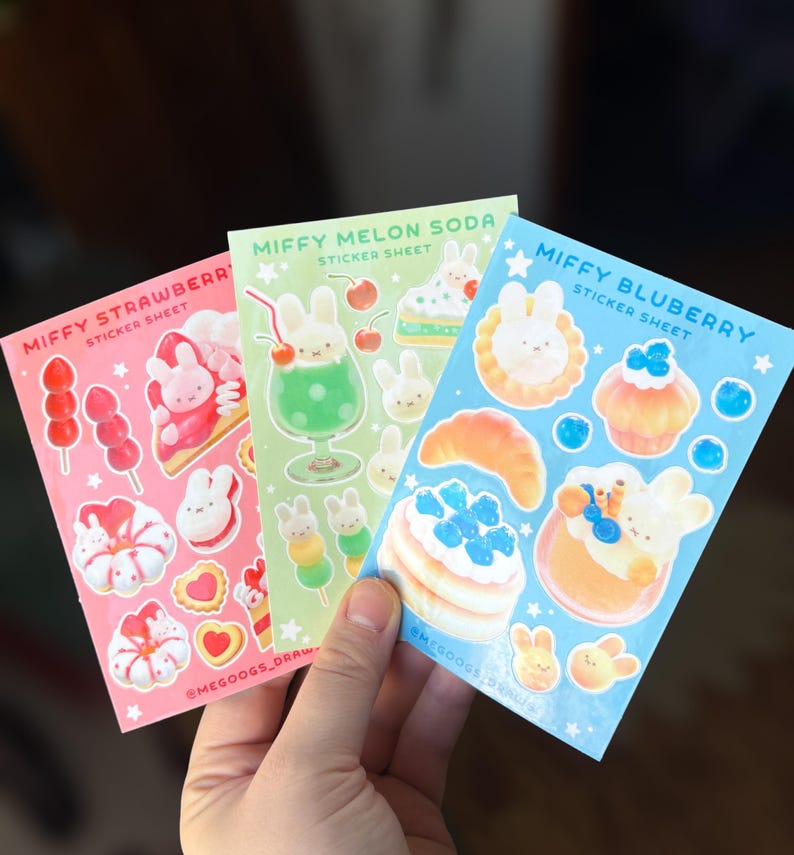 May include: Three sticker sheets featuring illustrations of a bunny character with food and drink themes. The sheets are labeled "Miffy Strawberry", "Miffy Melon Soda", and "Miffy Bluberry". Each sheet has a different color background.