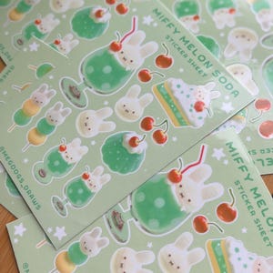 May include: Sheets of stickers featuring a cute bunny character with green melon soda, cherries, and cake illustrations. The stickers have a light green background with the text "MIFFY MELON SODA STICKER SHEET".
