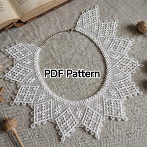 May include: A white beaded collar necklace featuring a geometric diamond pattern and intricate lace-like detailing. The center of the necklace displays the text PDF Pattern. The piece includes a silver-toned metal chain closure at the top.