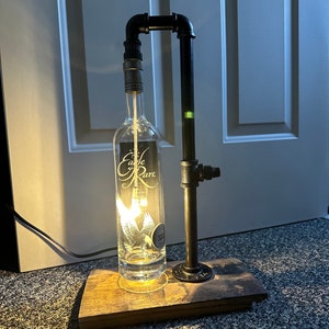 Eagle Rare  whiskey bottle pipe lamps with barrel stave base.