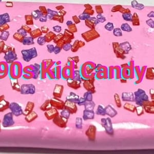 May include: Pink slime with red and purple sprinkles. The text "90s Kid Candy" is written in the centre of the slime.