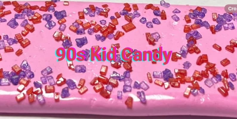 May include: Pink slime with red and purple sprinkles. The text "90s Kid Candy" is written in the centre of the slime.