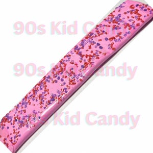 May include: Pink candy bar with red and purple sprinkles. The candy bar has the text "90s Kid Candy" printed on it.