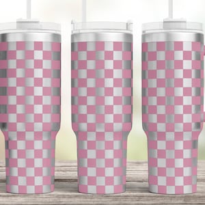 May include: Three stainless steel tumblers with a pink and silver chequered pattern. Each tumbler has a lid and a straw.