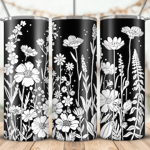 May include: Three black and white stainless steel tumblers with a floral design. The tumblers have a white floral pattern on a black background.