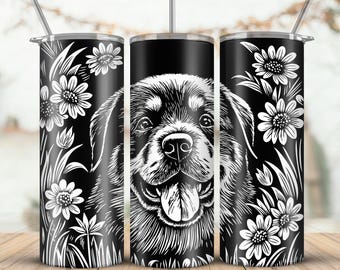 Puede incluir: Un vaso negro con una pajita de acero inoxidable, con una ilustración detallada en blanco y negro de la cara de un perro. Diseños florales y de hojas blancas en los lados.