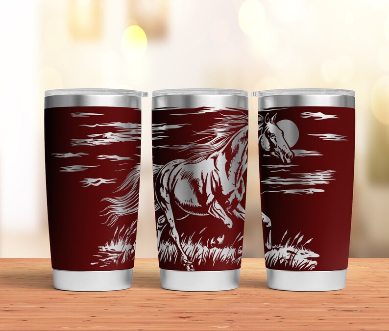 May include: Three stainless steel tumblers with a red exterior and a silver lid. Each tumbler features a laser-etched design of a horse running through a field with a moon in the background.