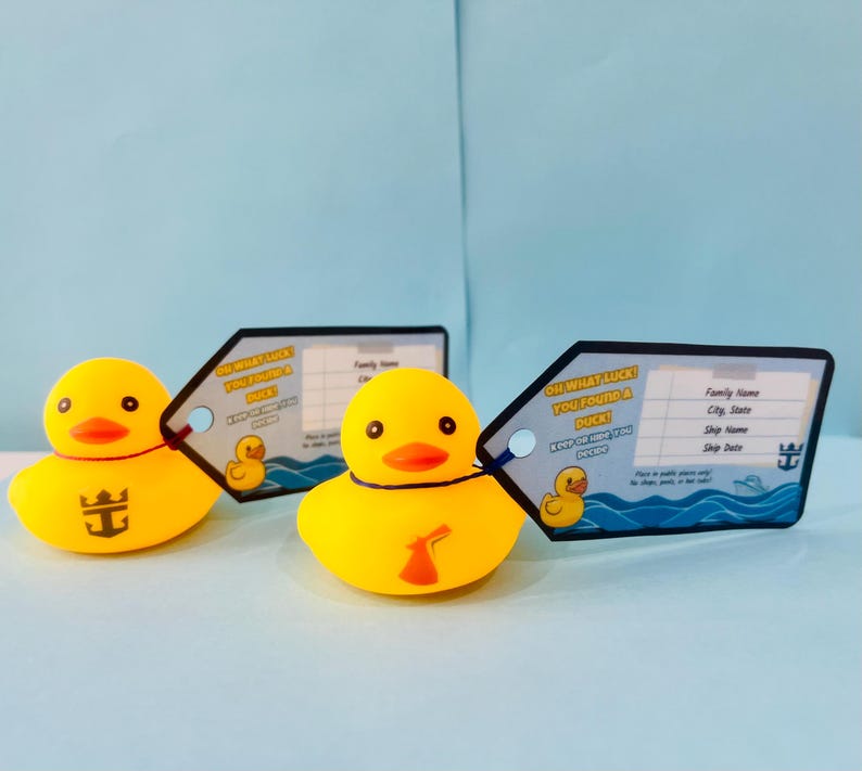 May include: Three yellow rubber duck toys with orange beaks and black eyes. Each duck has a tag that says "Oh what luck you found a duck!" and a place to write information. One duck has a logo on its chest.