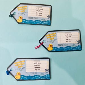 May include: Three luggage tags with a blue and white design. Each tag features a yellow rubber ducky, the text "OH WHAT LUCK! YOU FOUND A DUCK!", and space for personal information. The tags have a black border and a string for attachment.