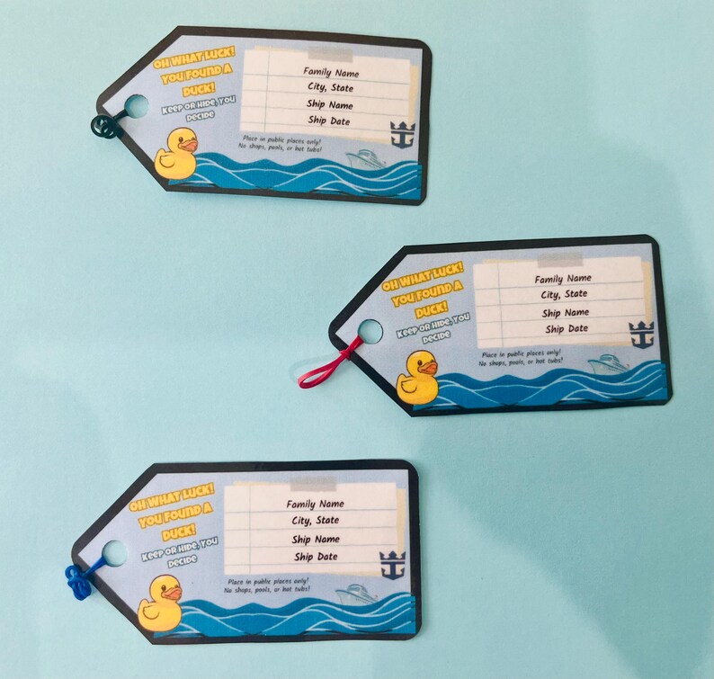 May include: Three luggage tags with a blue and white design. Each tag features a yellow rubber ducky, the text "OH WHAT LUCK! YOU FOUND A DUCK!", and space for personal information. The tags have a black border and a string for attachment.