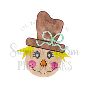 May include: A watercolor illustration of a scarecrow's face with a brown hat and a green bow. The scarecrow has a stitched smile, a brown nose, and pink cheeks.