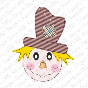 May include: A cute cartoon scarecrow with a brown and white striped hat, a yellow straw-like hair, and a stitched-on face with a brown nose and pink cheeks.