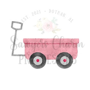 May include: A pink toy wagon with a gray handle and black wheels. The wagon has a red rim around each wheel. The text "EST. 2021 - DOTHAN, AL" is above the wagon.