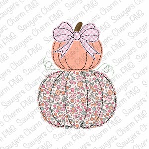 May include: Two pumpkins stacked on top of each other. The top pumpkin is a solid orange color with a pink and white gingham bow. The bottom pumpkin is covered in a floral pattern with pink, white, and light blue flowers.