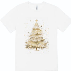May include: White t-shirt with a watercolour Christmas tree design. The tree is in gold and beige, with a star and gold speckles. A festive apparel item.