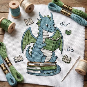 May include: A cross-stitch pattern on white Aida fabric featuring a blue dragon with green wings wearing glasses and reading a green book while sitting on a stack of books, surrounded by small book and glasses motifs, with embroidery floss and a needle.