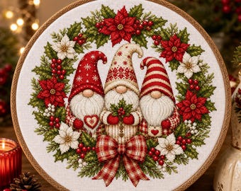 May include: A circular embroidery hoop containing a cross-stitch design of three gnomes wearing red and white hats. The gnomes are surrounded by a festive wreath of green pine needles, red poinsettias, white flowers, and red berries.