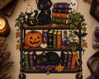 May include: A cross-stitch pattern on beige fabric featuring a three-tiered black metal cart. The cart holds black cats, stacks of colorful books with gold celestial symbols, a carved orange pumpkin, a small white ghost, and a potion bottle.