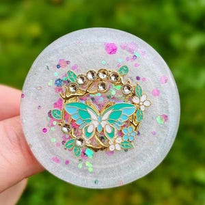 Handmade phone grip with "Golden Butterfly in a Frosted Garden." Comes with a transparent grip. Four styles to choose from.