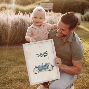 Light blue vintage race car wall art for nursery — charming watercolor illustration with a playful mood and black-and-white checkered flag backdrop.