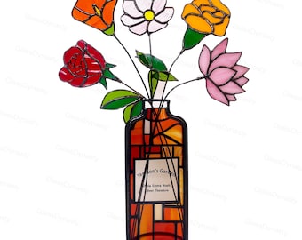 May include: Stained glass floral arrangement in a vase. The flowers include an orange poppy, white flower, yellow rose, red rose, and pink lotus. The vase is orange and brown with the text "Jackson's Garden" and names. Black metal frame.