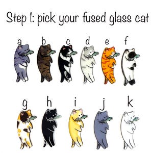 May include: Step 1: pick your fused glass cat.  A set of 11 fused glass cat figurines, each holding a fish. The cats are in various colors and patterns, including purple, brown, black, white, orange, yellow, and spotted.