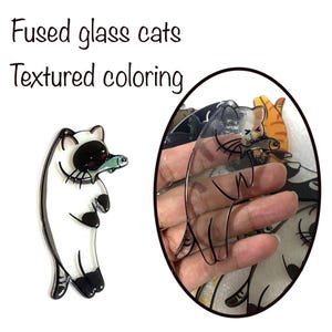 May include: Fused glass cat ornaments with textured coloring. One cat is holding a fish in its mouth. The text "Fused glass cats Textured coloring" is at the top of the image.