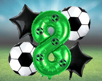 May include: A collection of soccer-themed balloons. A large green number eight balloon is decorated with small soccer ball graphics. Two black star-shaped balloons and two soccer ball-shaped balloons complete the arrangement, set against a gradient background.