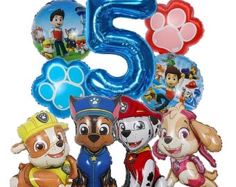 May include: A collection of colorful foil balloons featuring characters from the Paw Patrol animated series. Includes a large blue number 5 balloon, paw print balloons, and character-shaped balloons. Perfect for a birthday party.