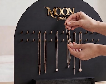 Personalized necklace organizer in matte black acrylic with gold hooks and gold text