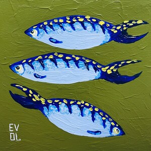 May include: An original painting featuring three stylized fish. The fish are light blue with dark blue and yellow accents. The background is a textured olive green. The artist's initials, "EV DL", are in the lower left corner.