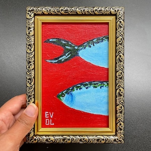 May include: A framed painting featuring two stylized fish against a vibrant red background. The fish are painted in shades of blue and green, with a dark tail. The frame is ornate, with gold and brown detailing. The initials "EV DL" are in the lower left corner.