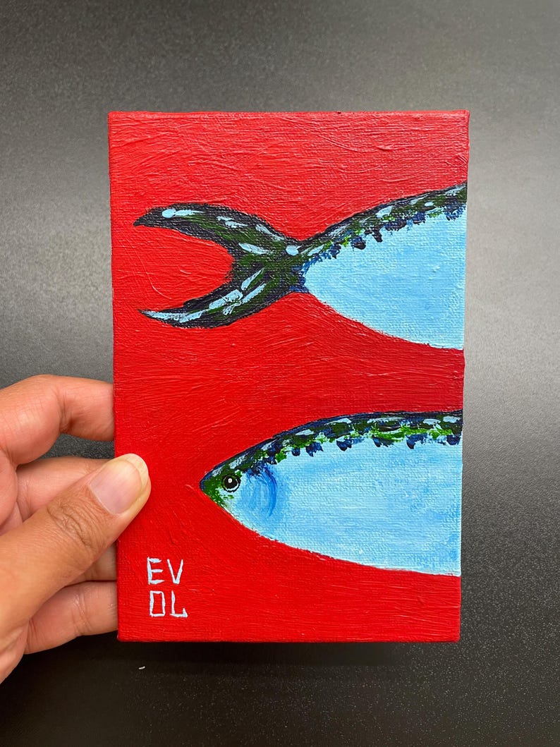 May include: Small rectangular painting featuring two stylized fish against a vibrant red background. The fish are painted in shades of blue and green, with a textured appearance. The artist's initials, "EV DL", are visible in the lower left corner.