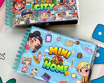 May include: Two spiral-bound notebooks featuring colorful cartoon character stickers. The top notebook displays the text "MINI CITY" with various figures, while the bottom notebook shows "MINI HOME" surrounded by illustrations of people and objects.