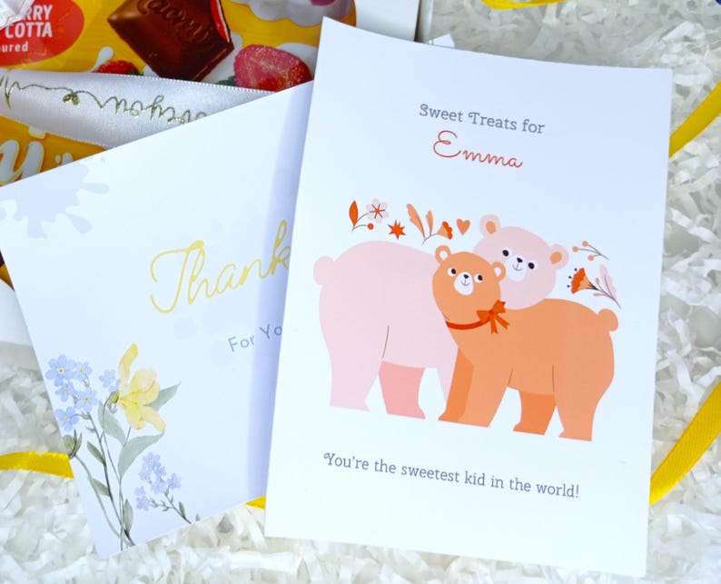 May include: Two greeting cards with text and illustrations. One card says "Thank You" with floral accents. The other says "Sweet Treats for Emma" with a bear illustration and the text "You're the sweetest kid in the world!"