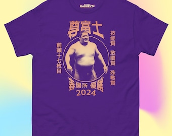 May include: Purple t-shirt with a graphic of a sumo wrestler in a circle. The text around the circle reads "尊富士" (Takayasu), "技能賞" (Skill Award), "敢闘賞" (Fighting Spirit Award), "殊勲賞" (Outstanding Performance Award), "前頭十七枚目" (Maegashira 17th Rank), "春場所 優勝" (Spring Grand Tournament Champion), and "2024".