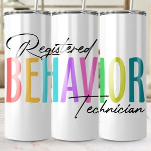 May include: White tumbler featuring the text "Registered Behavior Technician" in black script and colourful block letters. The tumbler has a silver lid and straw.