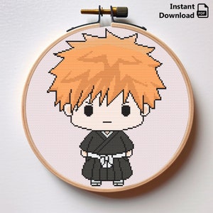 May include: Cross stitch pattern of a cartoon character with orange hair, wearing a black robe with a white belt. The character has a serious expression and is standing with their hands on their hips.