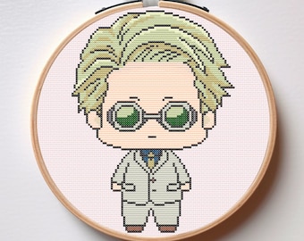 May include: Cross-stitch art of a cartoon character in a wooden embroidery hoop. The character has blonde hair, green-tinted glasses, and a white suit. The text "Instant Download PDF" is in the upper right corner.