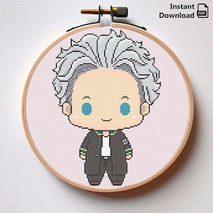May include: Cross stitch pattern of a cartoon character with gray hair, wearing a black jacket, white shirt, and black pants. The character has blue eyes and a smile. The pattern is displayed in a wooden embroidery hoop.