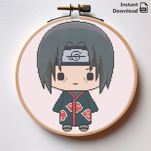 Może przedstawiać: Wzór haftu krzyżykowego przedstawiający postać z kreskówki z czarnymi włosami, niebieską opaską na głowie z symbolem spirali, czerwoną i zieloną koszulą oraz czerwonymi oznaczeniami na koszuli. Postać znajduje się w drewnianym obręczy do haftu.