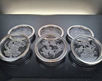 6 crystal coasters with silver-plated edge.