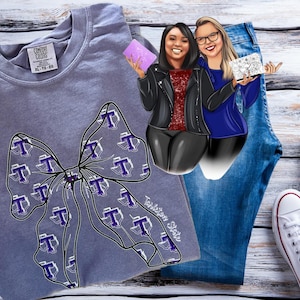 May include: A gray Comfort Colors t-shirt with a large bow design filled with purple and white "T" logos. The image includes a pair of blue jeans, white sneakers, and a cartoon illustration of two women.