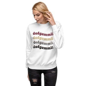 May include: White sweatshirt with the phrase "dadgummit" repeated four times in different colors: burgundy, gray, beige, and black.