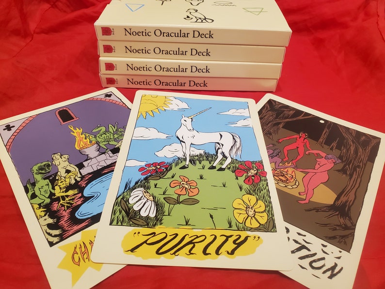 May include: Three tarot cards with colorful illustrations. The card on the left shows a green creature with a fire behind it. The middle card shows a white unicorn in a field of flowers with the word "PURITY" written below. The card on the right shows a group of people dancing around a fire in a dark forest.