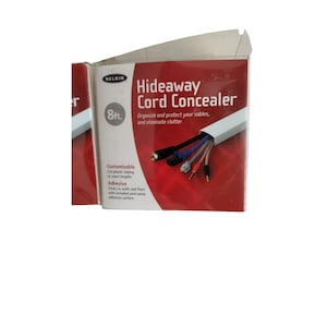 May include: White cord concealer packaging with red background. The packaging shows a white cord concealer with wires running through it. The text on the packaging reads "Hideaway Cord Concealer" and "8ft."