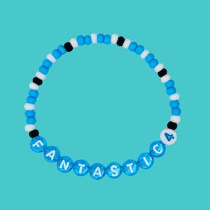May include: A blue and white beaded bracelet with the word "FANTASTIC" and the number "4" spelled out in white letters.