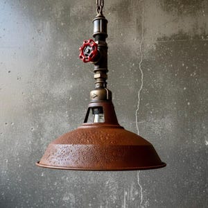 May include: Industrial-style pendant light with a rusty brown shade and a red valve detail. The fixture is suspended from a chain and features exposed piping and a vintage aesthetic. The light has a diameter of approximately 12 inches.
