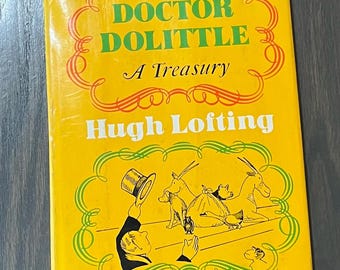 May include: A yellow book cover with the title "Doctor Dolittle A Treasury" by Hugh Lofting. The cover features a black and white illustration of Doctor Dolittle with animals.